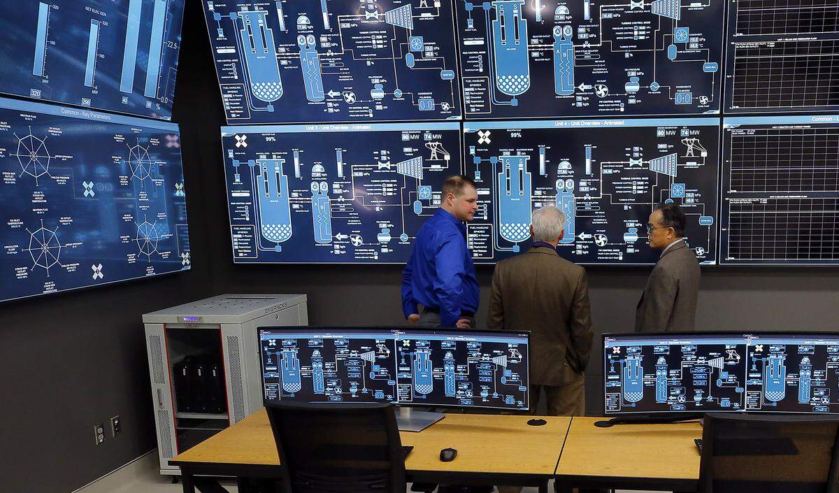 Visitors take a closer look at the Small Modular Reactor simulator during an open house ceremony at The WSU Tri-Cities Institute for Northwest Energy Futures is 2892 Pauling Ave. in Richland.