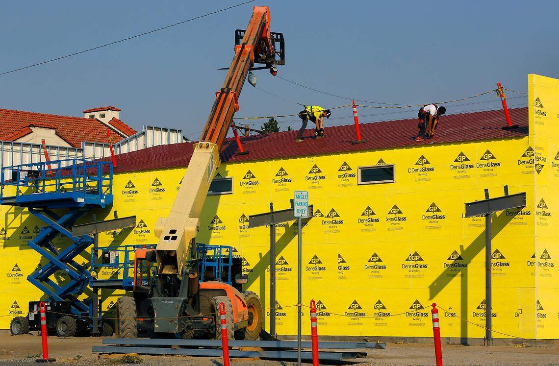 Construction workers screw down the metal roof on a 4,560-square-foot annex being built next to the Franklin County Historical Society Museum in Pasco. The annex will add space for exhibits, educational programs and archive storage. The main museum is a restored 1911 Carnegie Library and National Historic Site.