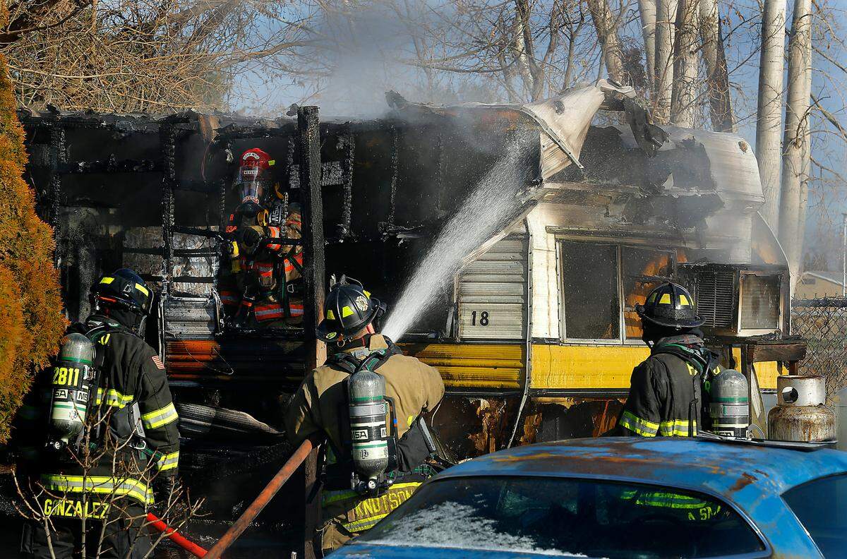 Firefighters extinguish hot spots at a trailer fire Monday morning at 832 N. Third Ave. in Pasco after a resident was apparently trying to thaw frozen pipes shortly before the fire started, said Pasco Deputy Fire Chief Ed Dunbar. Two people inside when the blaze began safely escaped.