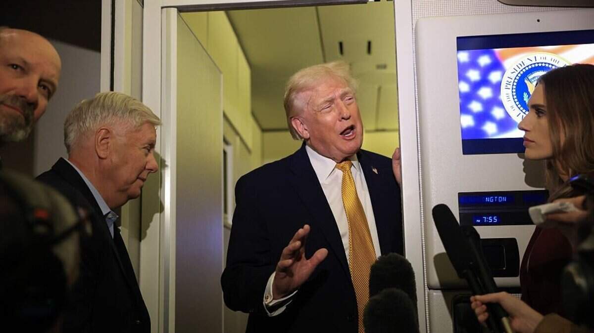 IN FLIGHT - JANUARY 04: U.S. President Donald Trump, Commerce Secretary Howard Lutnick (L) and U.S. Sen. Lindsey Graham (R-SC) (C) speak to the media aboard Air Force One enroute to Washington, DC on January 04, 2026. Trump is returning to the White House after giving the order for the United States law enforcement to capture Venezuelan President NicolÃ(degrees)s Maduro and his wife. (Photo by Joe Raedle/Getty Images)