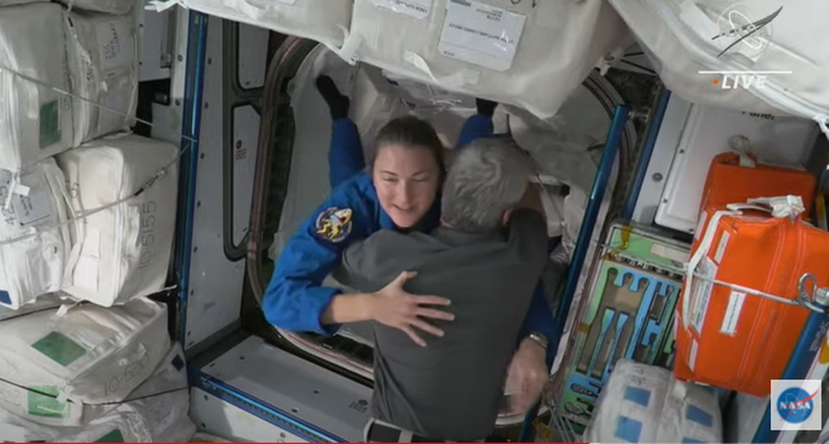 A screenshot from a NASA live webcast shows NASA astronaut Kayla Barron, of Richland, floating through the hatch of her spacecraft into the International Space Station to be greeted with a hug Thursday.