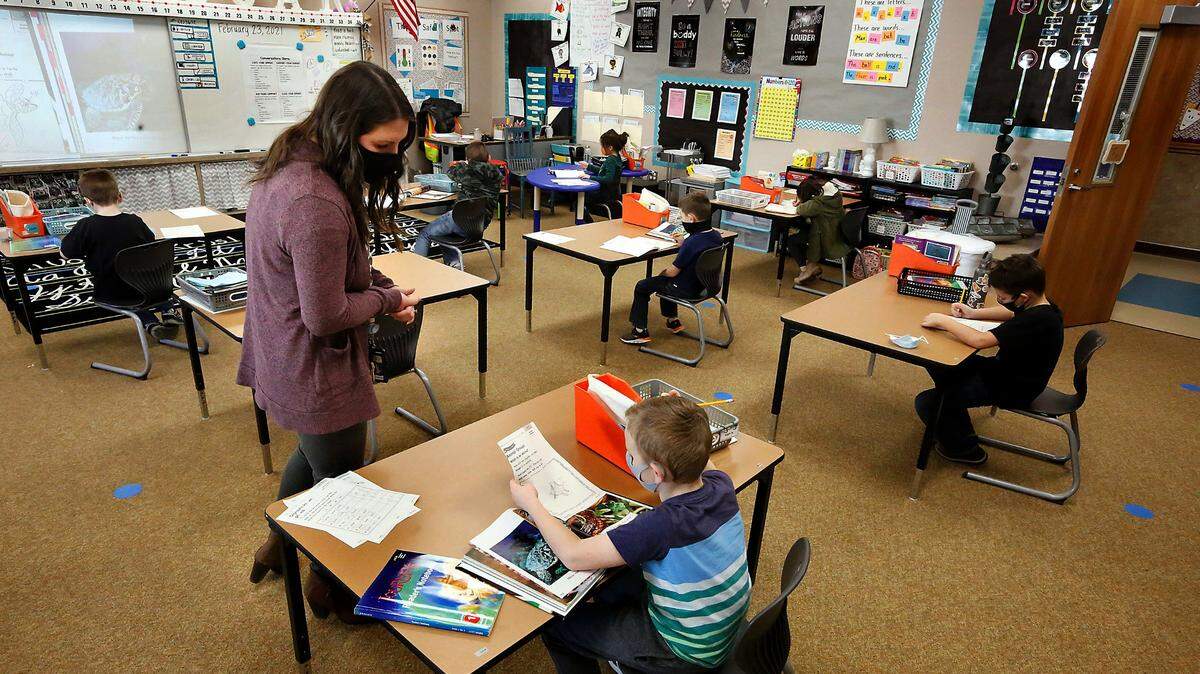 Reading scores saw their largest decrease in 30 years, and math scores decreased for the first time in the history of a national study. This file photo shows Pasco students in a first-grade classroom at McClintock STEM Elementary during the pandemic.