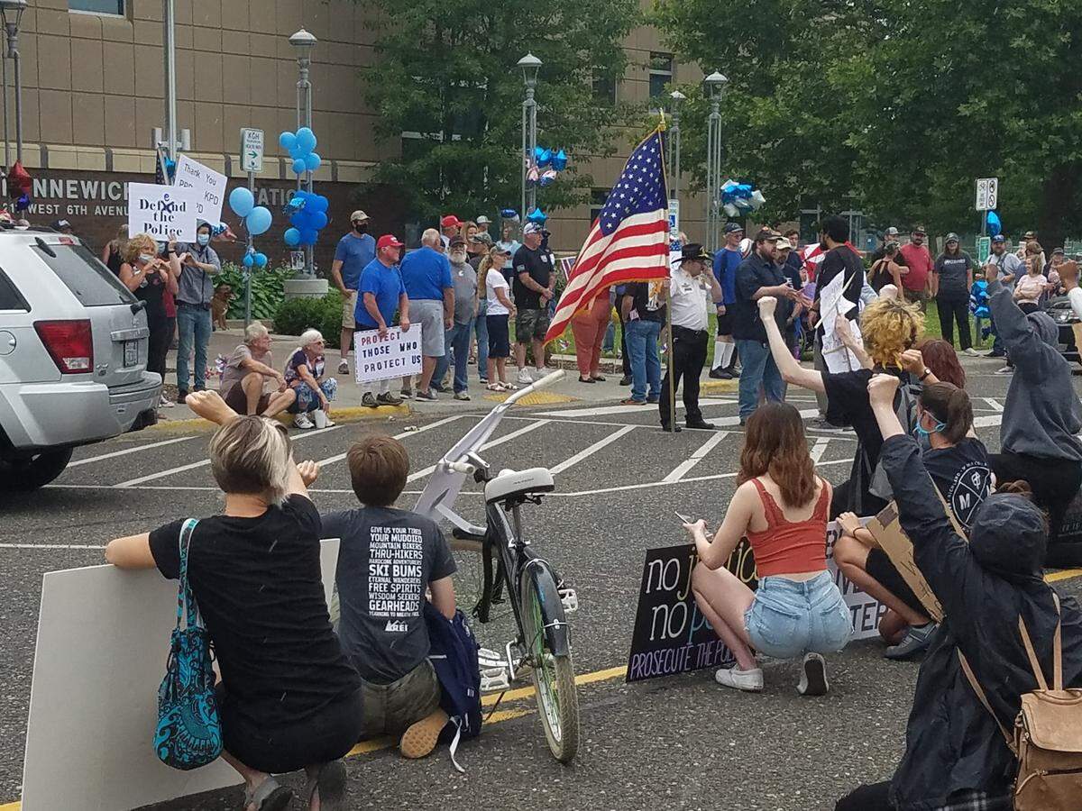 About 100 Black Lives Matter protesters faced off Saturday afternoon with a similar size group rallying in front of the Kennewick Police Department in support of the police.