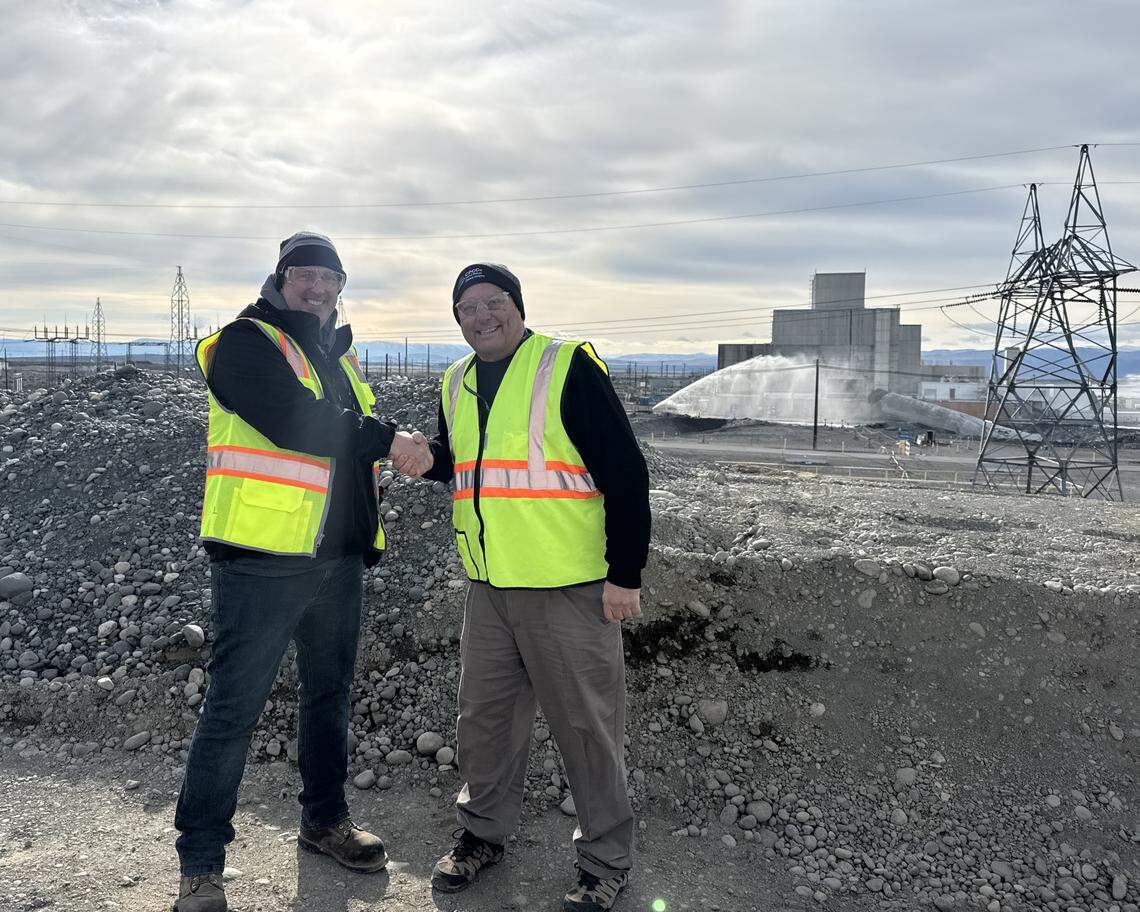 Explosives were used Friday afternoon to topple the 175-foot-tall exhaust stack of the K West Reactor at the Hanford nuclear site in Eastern Washington. CPCCo Chief Operations Officer Bill Barrett and DOE Hanford Site Manager Ray Geimer congratulate each other after the stack is down.