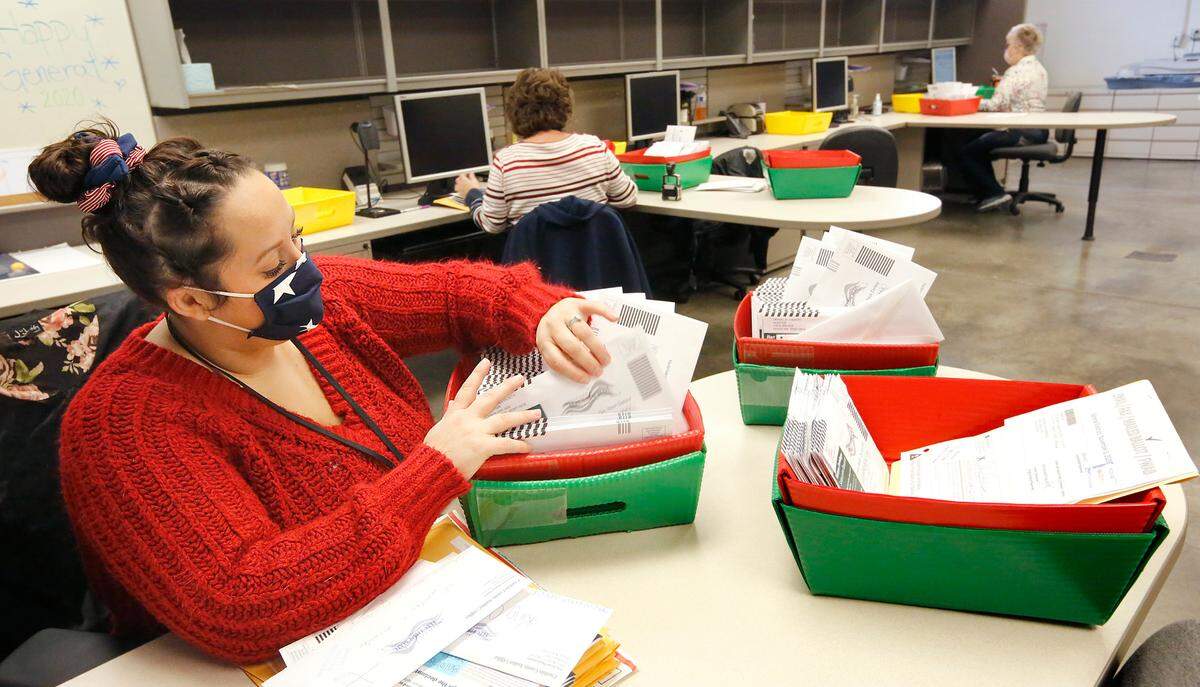 Franklin County Elections assistant Shannon Kimball counts batches of ballots from drop boxes Tuesday to start the process of verifying and tabulating them at the Franklin County Election Center in Pasco.