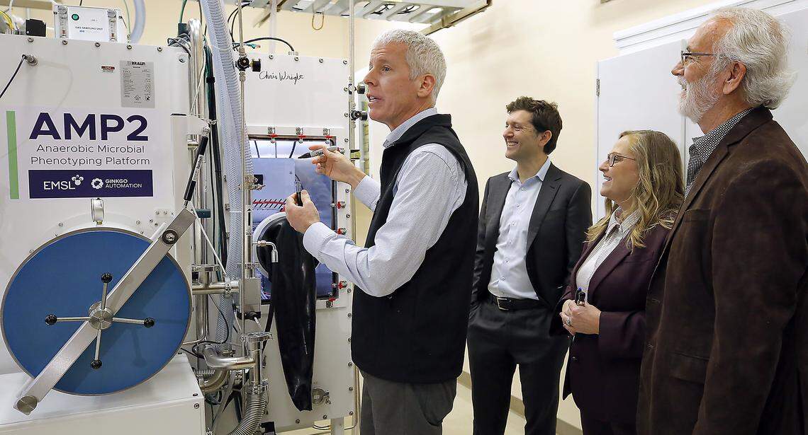 U.S. Secretary of Energy Chris Wright commissions new Anaerobic Microbial Phenotyping Platform, known as AMP2, with his signature Thursday during his visit to the Pacific Northwest National Laboratory in Richland. Watching, from left, are CEO Jason Kelly of Ginkgo Bioworks, PNNL director Deb Gracio and U.S. Rep. Dan Newhouse (R-Wash.). 