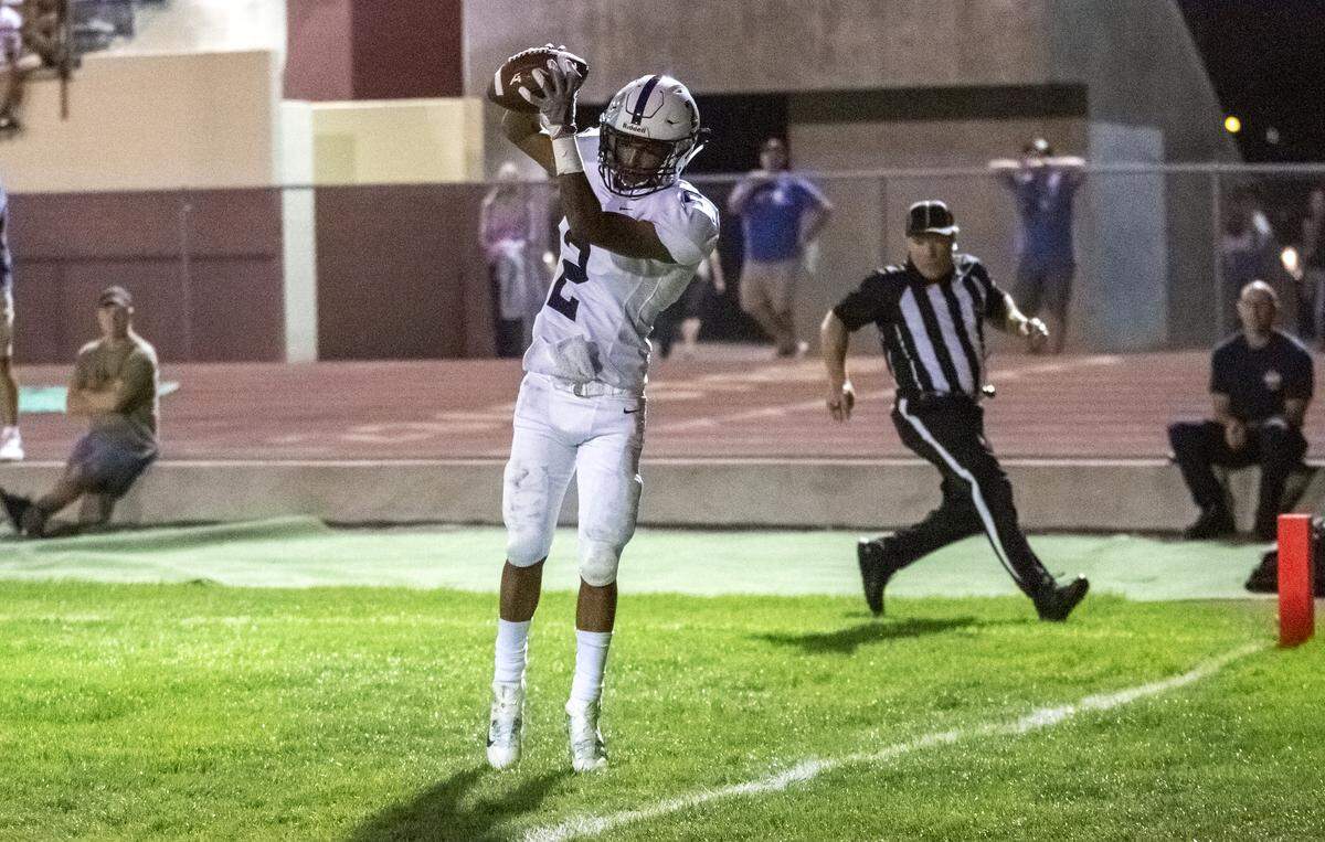 Chiawana’s receiver Dion Lee (2) catches the touchdown pass from quarterback JP Zamora during a Mid-Columbia Conference football game against Richland High School at Fran Rish Stadium on Friday. Chiawana defeated Richland 38-7.