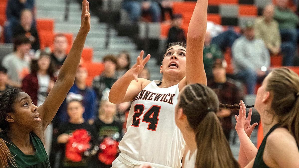 Kennewick’s MeiLani McBee puts up a shot against multiple Richland defenders during a recent game. McBee currently leads the team at 15.2 points a game.