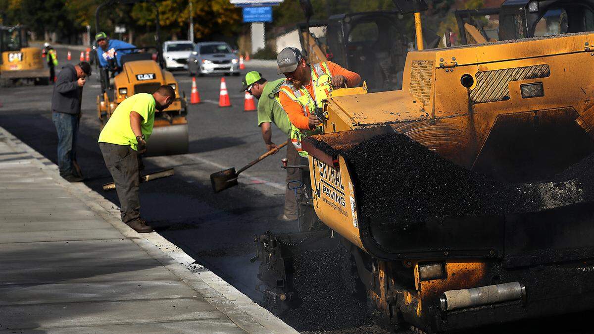 Ben Hawkinn with Central Paving controls the tracked paving machine at the Steptoe Street and Gage Boulevard intersection project by the city of Kennewick in this file photo.