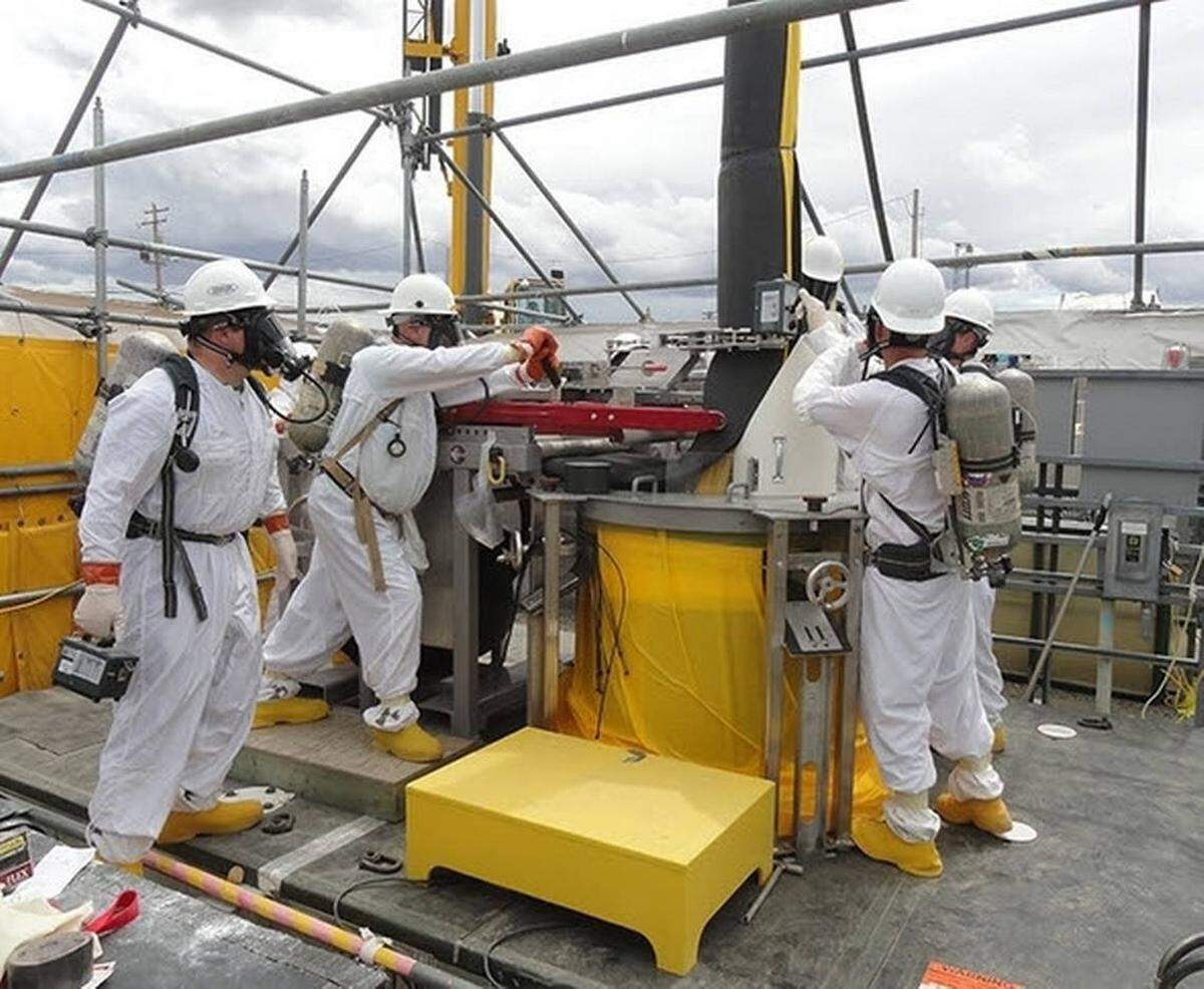 Hanford workers remove a failed pump from one of the nuclear reservation’s underground tanks used to store 56 million gallons of radioactive waste.