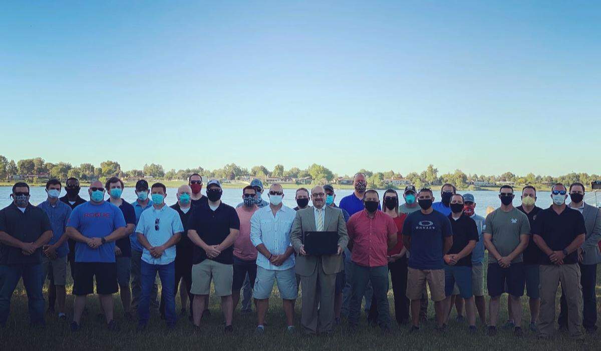 More than two dozen members of the Benton County Deputy Sheriff’s Guild stand with union lawyer Alan Harvey of Vancouver, Wash. Harvey recorded a video statement about the guild’s June vote to recall their boss, Sheriff Jerry Hatcher.