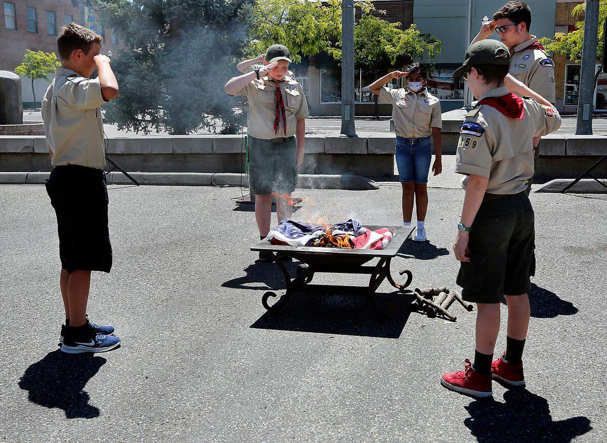 Members of the Boys Scouts of America Blue Mountain Council pay a fitting and respectful tribute during Monday’s formal flag retirement and disposal ceremony held by the Historic Downtown Kennewick Partnership. About 50 people attended the Flag Day event which followed protocols established by the United States Flag Code. From left, are: Ryker Harris, Jude Macduff, Aashrita Bhamidimarri, Brendon Eickerman and Conner Goodsel.