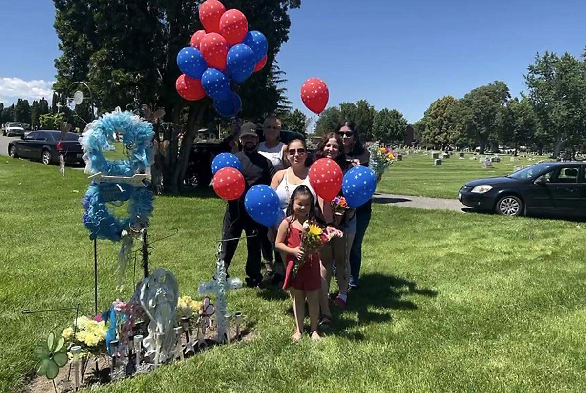 Sally Madrigal, back left, is pictured with her family.