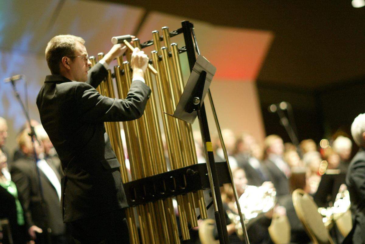An unidentified percussionist plays the chimes during the Mid-Columbia Symphony’s 2010 Christmas concert.