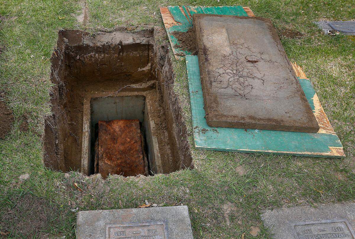 The wood casket of Baby Doe sits in the ground before it was exhumed Tuesday at the Resthaven Cemetery in Richland for DNA testing.