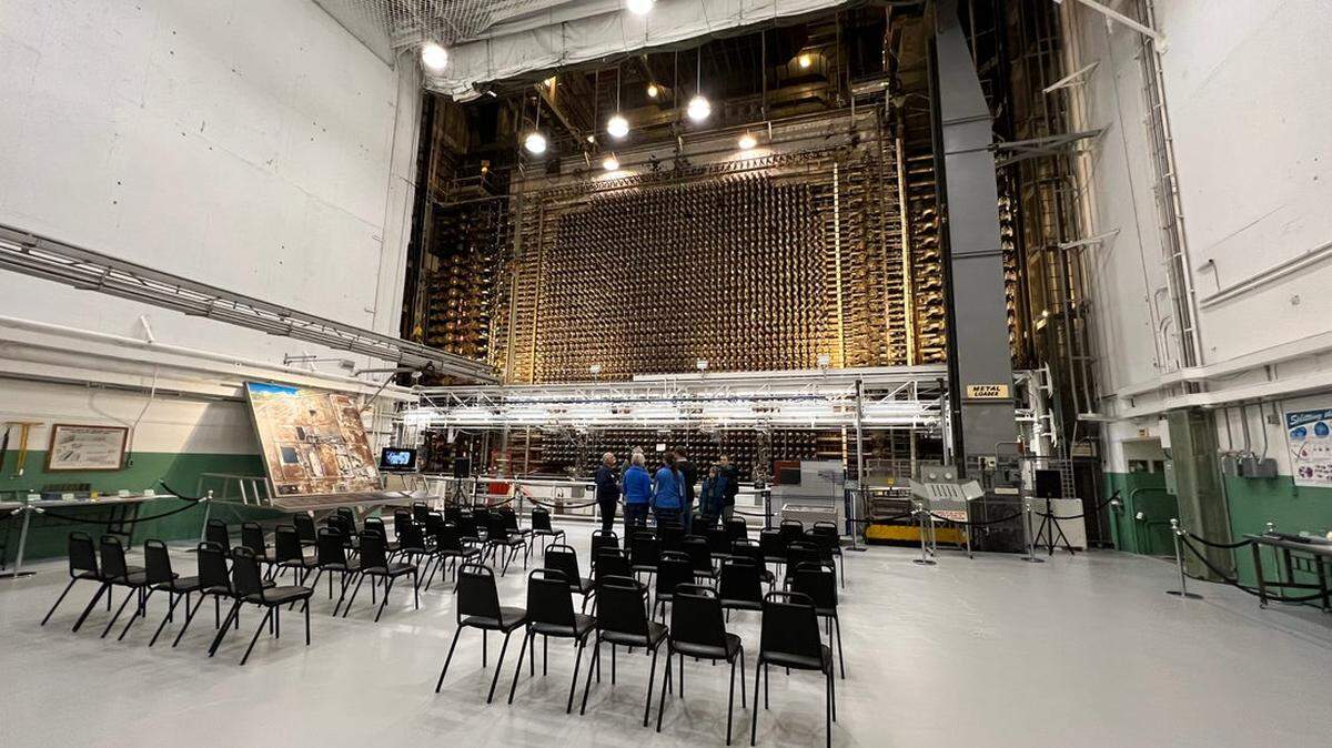A group of visitors stands in front of the front face at B Reactor.