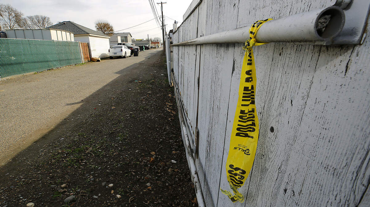Crime scene tape hangs from a fence in an alley south of Sylvester Street where a stabbing appears to have taken place on Monday night.