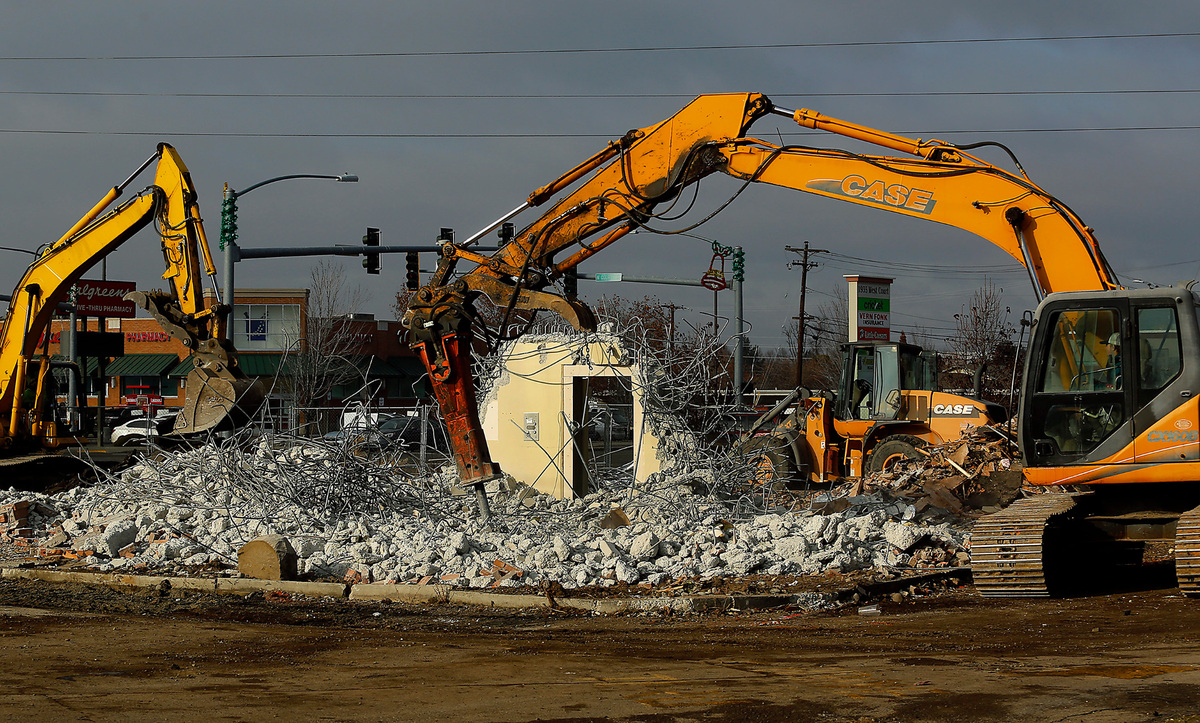 An excavator with a powerful chisel attachment works at breaking apart a bank vault at the former U.S. Bank branch on West Court Street in Pasco. The demolition work is part of a project to redevelop the site for a new Bruchi’s CheeseSteaks & Subs restaurant and a Baskin Robbins ice cream shop.