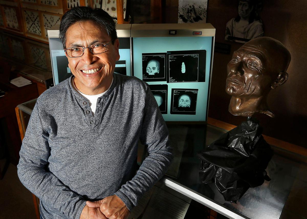 Javier Sanchez recently stands near the bronze bust of “The Ancient One” or Kennewick Man at the East Benton County Historical Museum. An at-home DNA test revealed a genetic link. Watch a video at: tricityherald.com/video