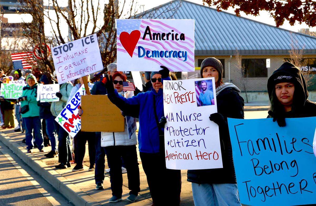 Shannon Hubbard holds a sign at a Richland protest Sunday after the killing of Alex Pretti, a nurse in Minneapolis, by immigration agents. The Tri-Cities demonstration was Sunday at John Dam Plaza in Richland.