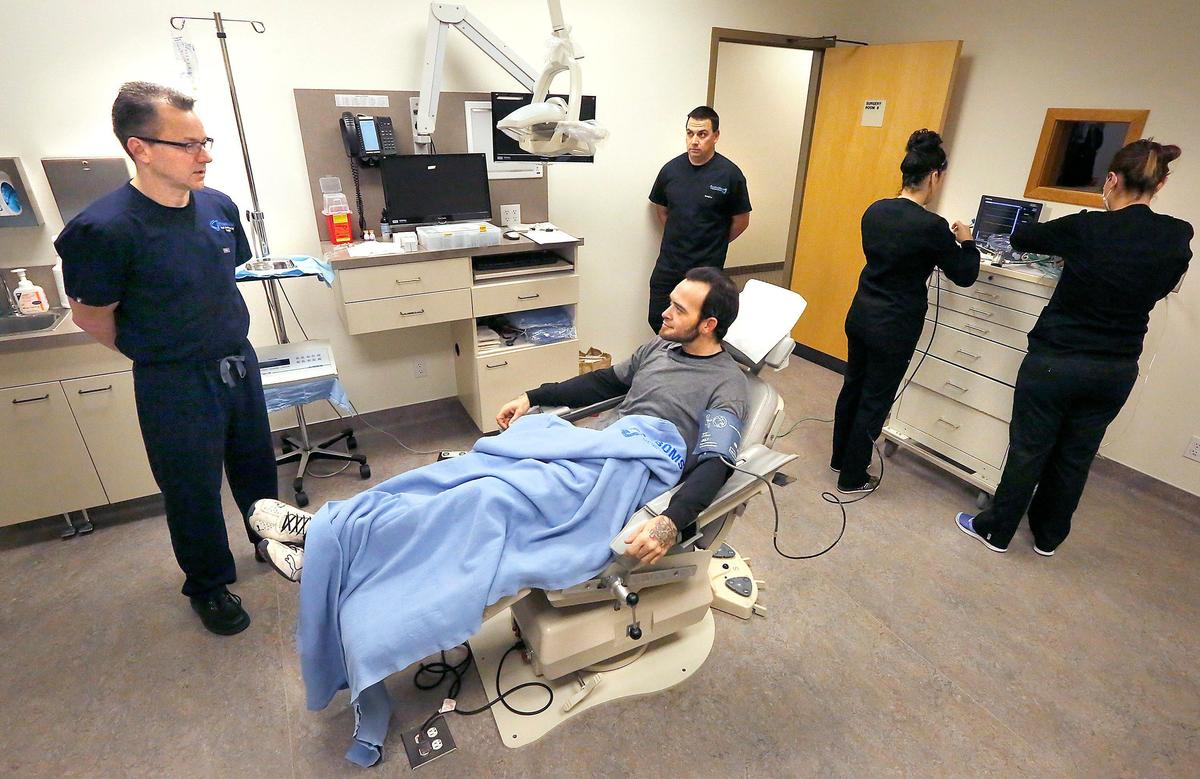 Smile Again Surgery winner Brian Willard, 33, of Richland receives final information about his estimated 5-hour procedure from oral surgeon Todd Cooper, left, and dentist Sean Simper of Southridge Dental early Monda. Watch a video at: tricityherald.com/video