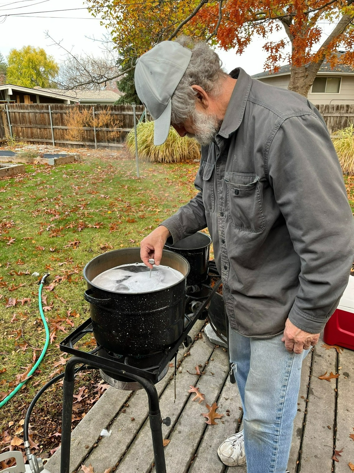 Ted Poston checks to see if the scalding bath, the first step in the plucking process, has reached the proper temperature of 150 F.