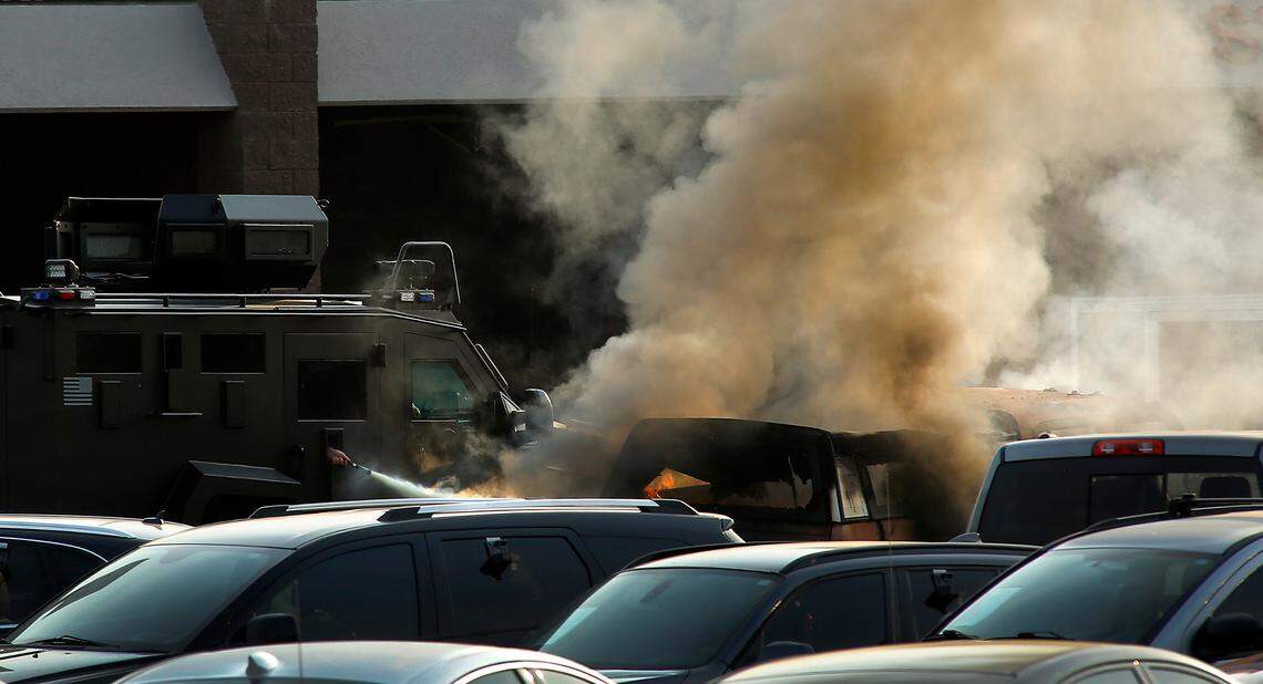 A fire extinguisher is sprayed on a burning pick-up truck from inside the Tri-Cities Regional SWAT vehicle Wednesday morning at the entry to the The Wash Stop coin-operated car wash at 4024 W. Van Giesen St. in West Richland. The scene is apparently connected to a violent, fiery rampage that stretched from Finley to West Richland ended with an officer-involved shooting.