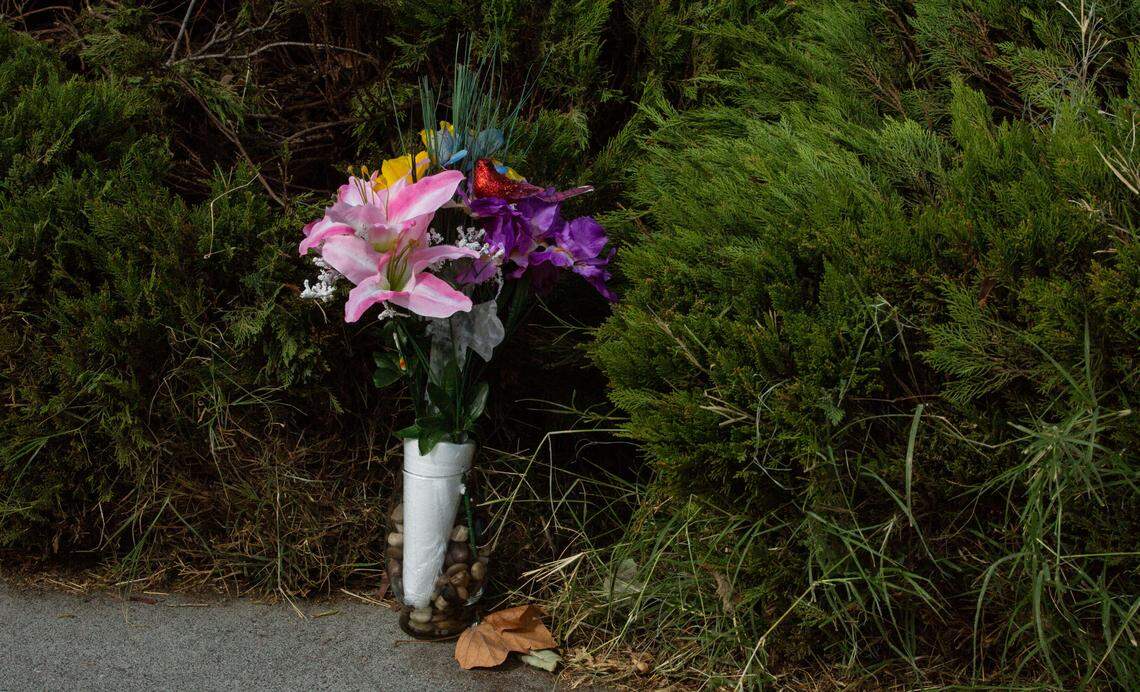 A vase of faux flowers stands as a memorial for the Pasco School District bus driver who was stabbed outside of Longfellow Elementary on Friday. The driver, Richard Lenhart, 72, of Kennewick, died from wounds he sustained from the attack, which happened in front of over 30 children who had already boarded for afternoon dismissal.
