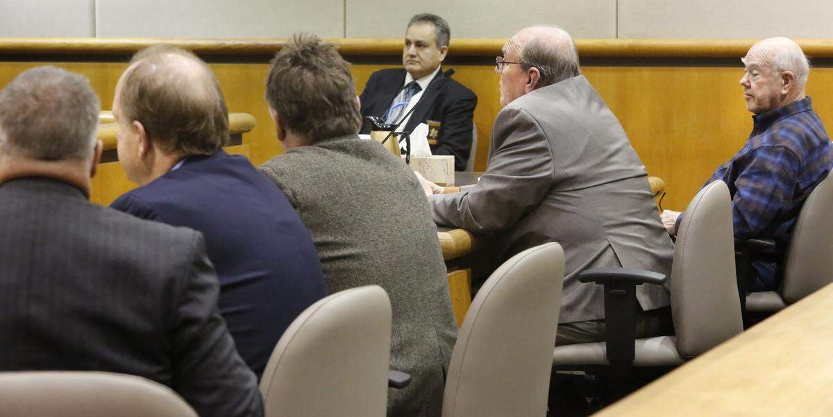 Kennewick resident Richard Bilskis (with glasses) and Jerry Martin (wearing plaid) listen to Judge Bruce Spanner during Wednesday’s hearing in the petition recall of Kennewick Mayor Don Britain. Seated at left are attorney Kevin Holt, Don Britain and attorney Bob Thompson. Watch video at: tricityherald.com/video