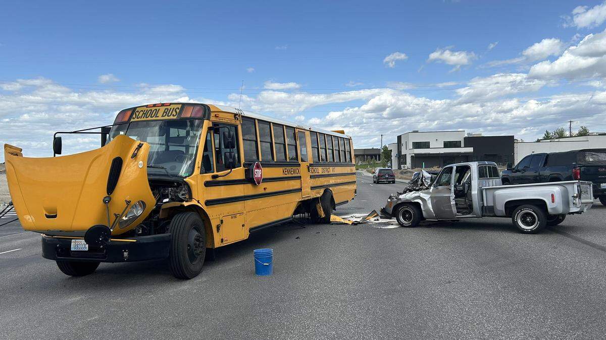 A Kennewick school bus with students on board collided with a pickup truck Wednesday at a busy intersection.