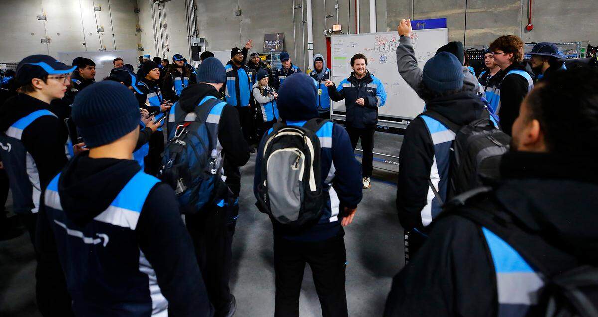 Brad Wilson conducts a conducts a driver’s meeting at the new Amazon delivery station in Pasco prior to them heading out to make deliveries to the Tri-Cities area.