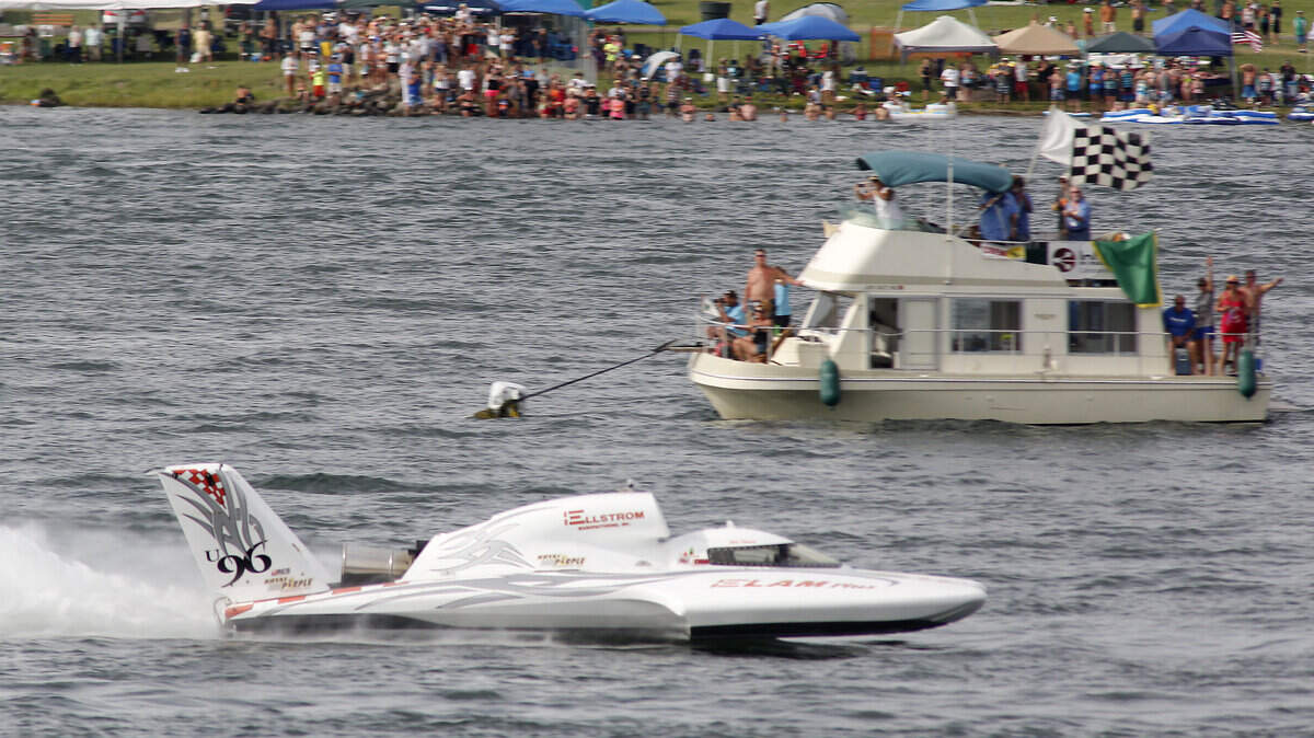 Jean Theoret takes the checkered flag in the U-96 unlimited hydroplane at the finish line of the Gold Cup. He was disqualified.