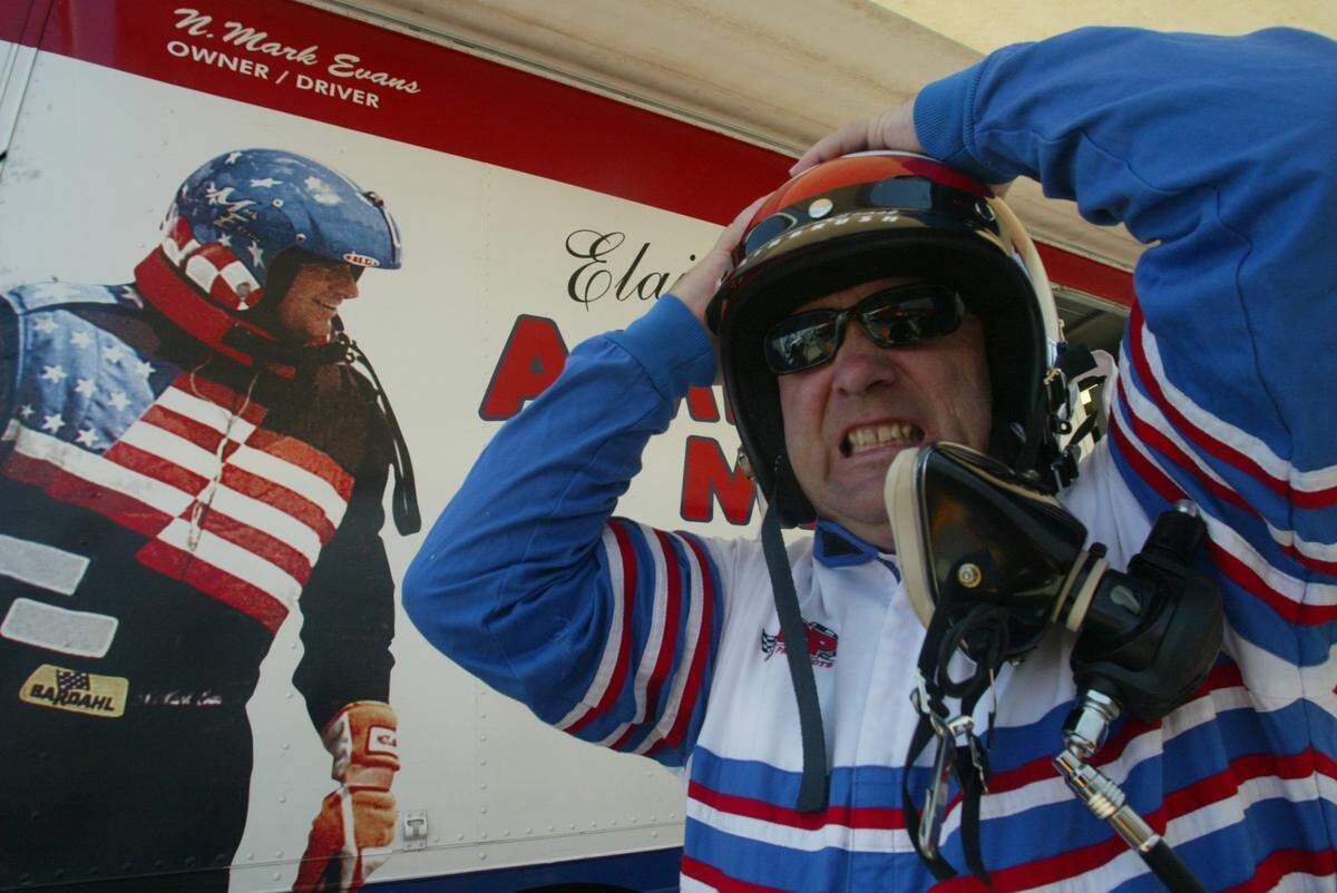 Intrepid Herald sports editor Jeff Morrow pulls on his racing helmet before taking a ride with hydroplane driver/owner Mark Evans on the Columbia River in 2004.