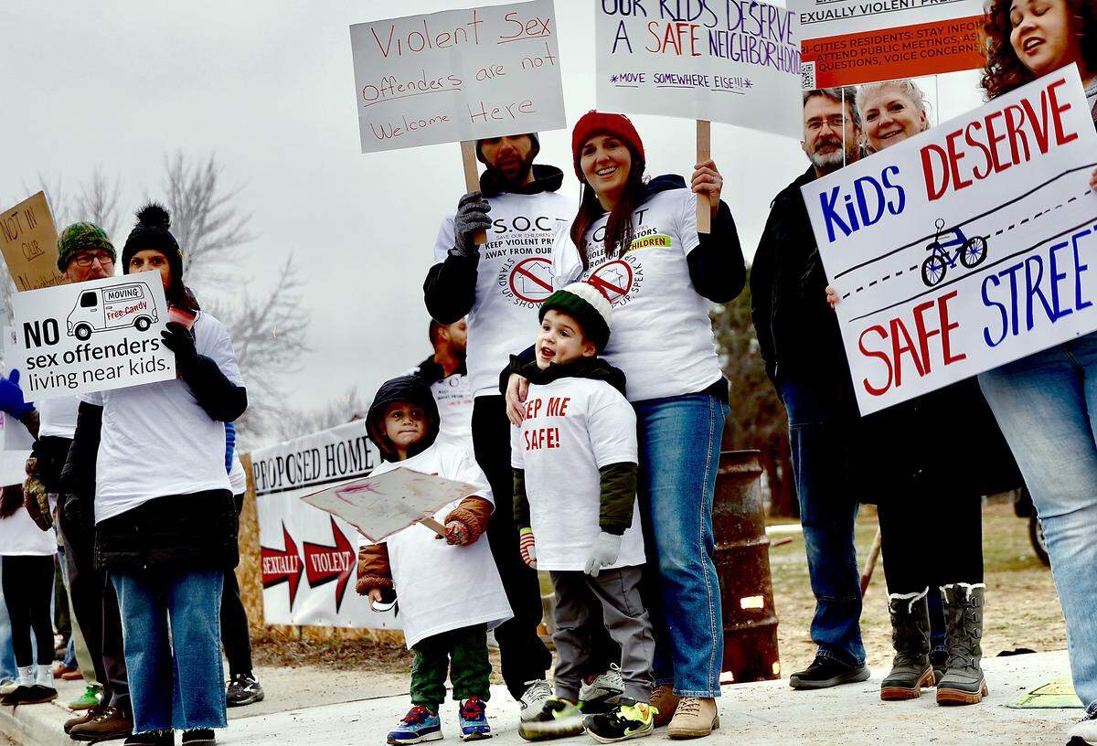 Local families and residents of West 8th Avenue protest recently along Edison Street in Kennewick The group is opposed to a decision to allow a home for Level-3 sex offenders on West 8th Avenue.