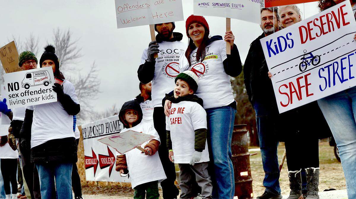 Local families and residents of West 8th Avenue protest along Edison Street in Kennewick The group is opposed to a decision to allow a home for Level-3 sex offenders on West 8th Avenue.