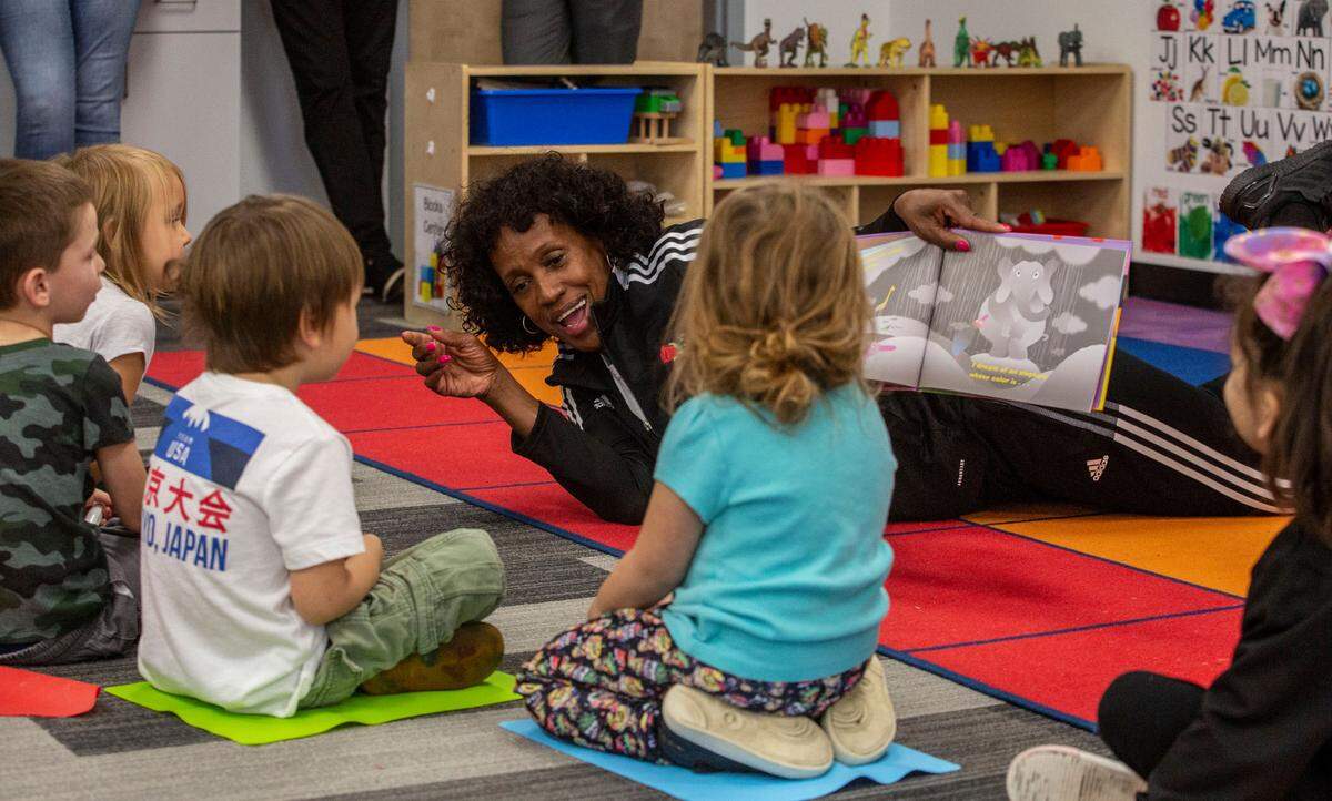 Olympic legend Jackie Joyner-Kersee reads a book to a preschool class during a visit to the Boys & Girls Club in Kennewick this week.