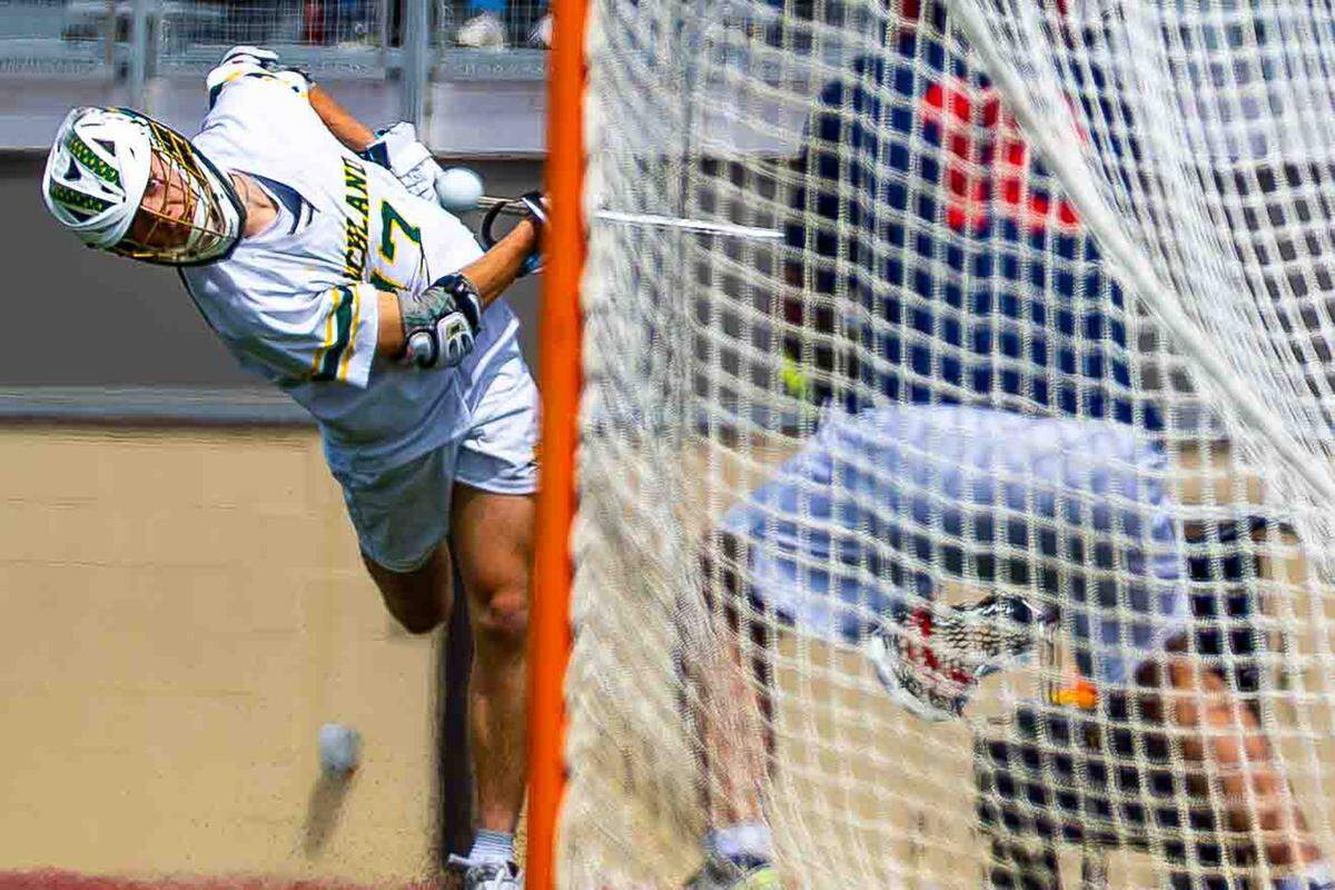 Richland junior Jack Henrie (17) attempts a wraparound shot from behind the goal during the Bombers’ 18-4 playoff win over Juanita on Saturday at Fran Rish Stadium in Richland.