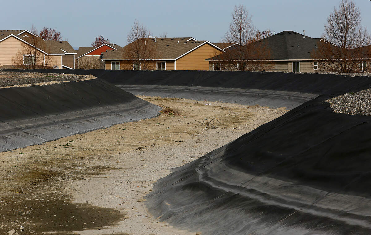 A Kennewick Irrigation District canal remains empty near Creekstone Drive in Kennewick after the agency announced a delay in their filling of the irrigation canal system for the 2022 season.
