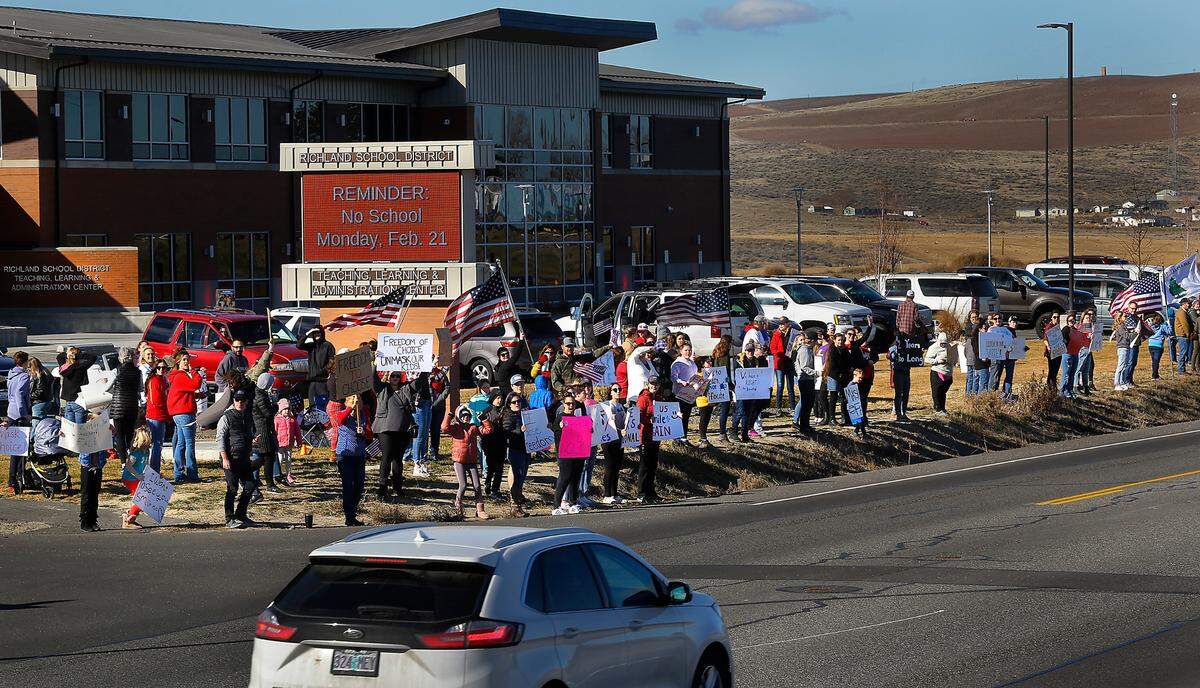 Two student-organized rallies supporting mask-choice, voted in by the Richland School Board the previous night, attract about 75 students and parents at the school administration building on Keene Road in West Richland on Wednesday. Schools were closed Wednesday after the board decision.