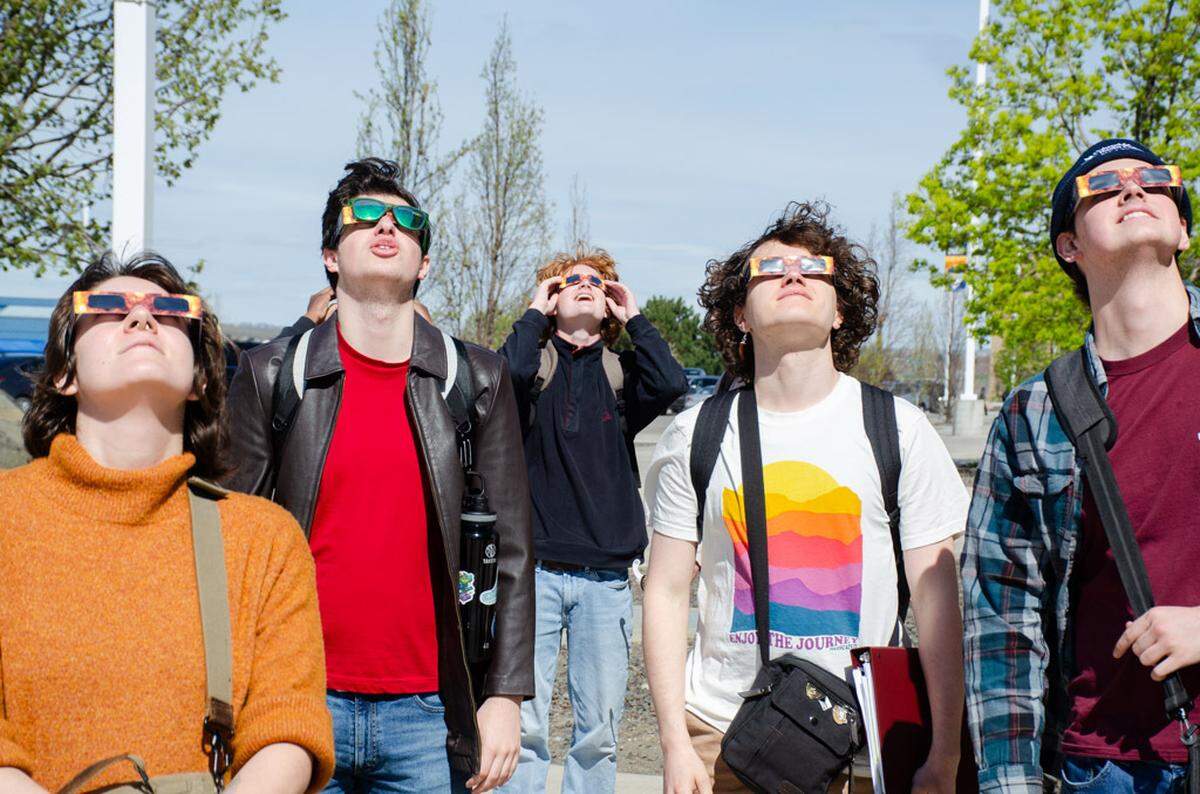 Students at Columbia Basin College in Pasco, Wash., stop to watch the 2024 North American total solar eclipse.