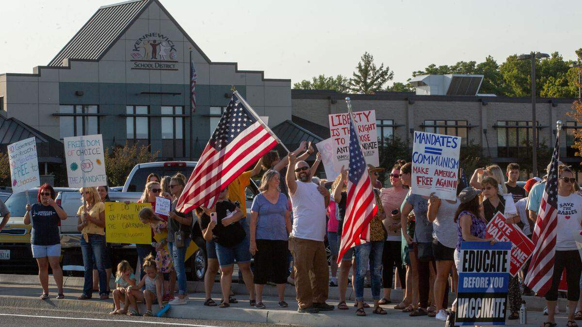 Hundreds rallied along West Fourth Avenue outside of the Kennewick School District administrative building on in August 2021 in protest of Washington Gov. Jay Inslee’s mask and vaccine mandates.
