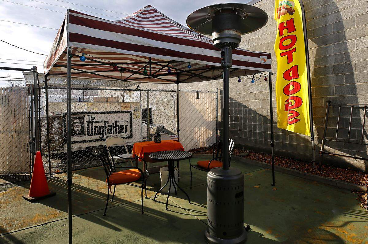 Dogfather owners Malinda Ralston and her fiance, Troy Collins, will serve up their popular hot dogs, hamburgers and more the first week of December .