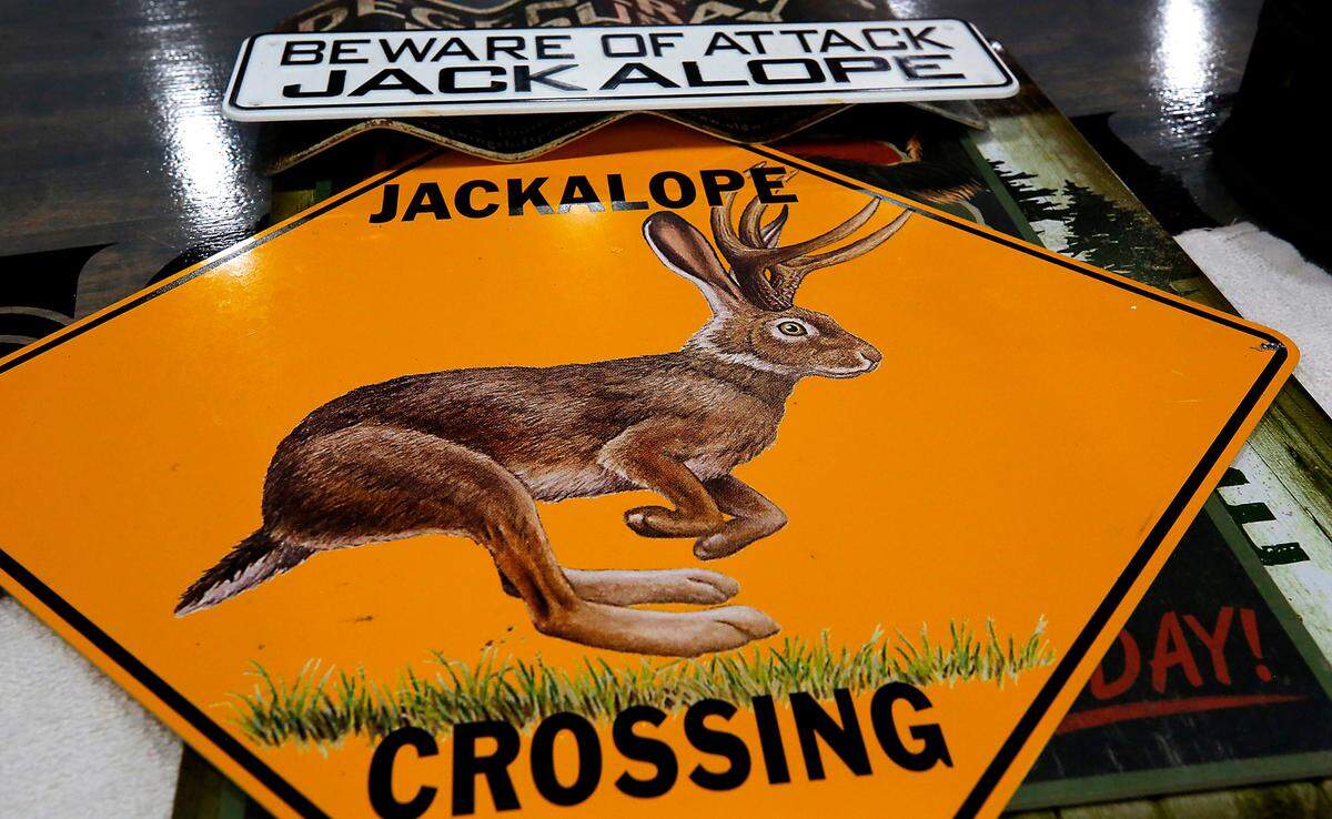 Metal signs about the mythical hybrid creature sit on a table inside the new location of the Jackalope Bar & Grill at 3320 W. Kennewick Ave.