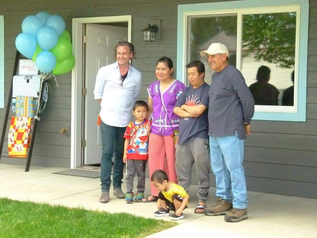 A family of four receives their keys at Habitat for Humanity’s 150th home dedication.