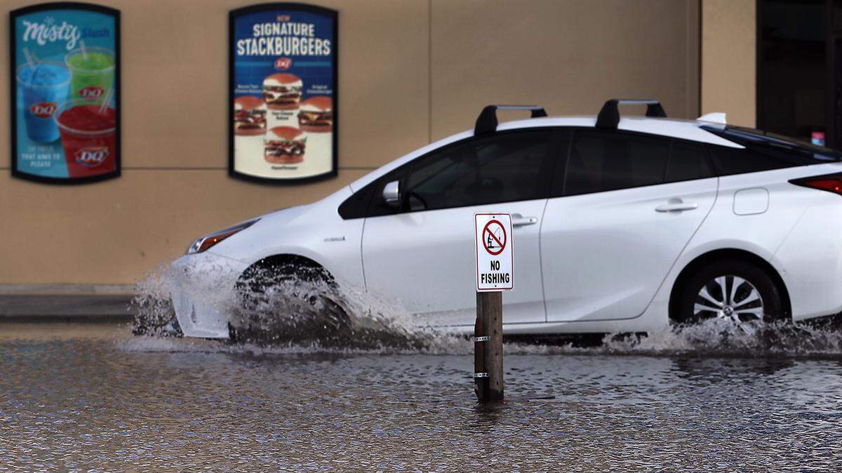 A driver splashes through “Lake Dairy Queen” Thursday in a parking lot off Jadwin Avenue in Richland following a day of rainfall in the Tri-Cities.
