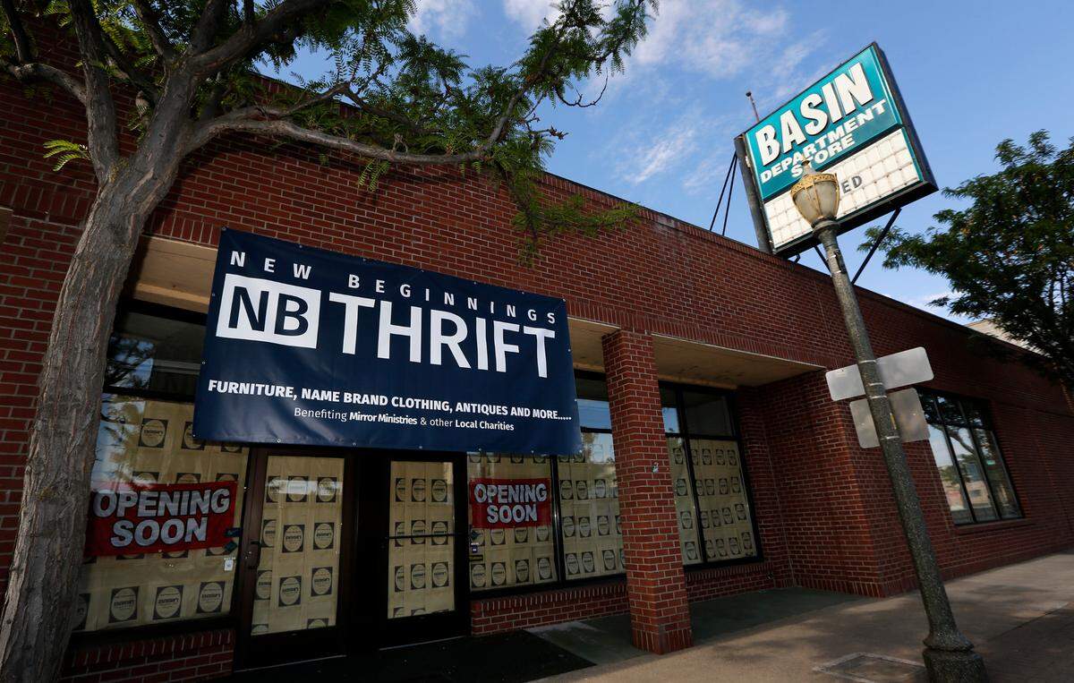 A banner advertises for New Beginnings Thrift to open soon in the former Basin Department Store building on West First Avenue in downtown Kennewick.