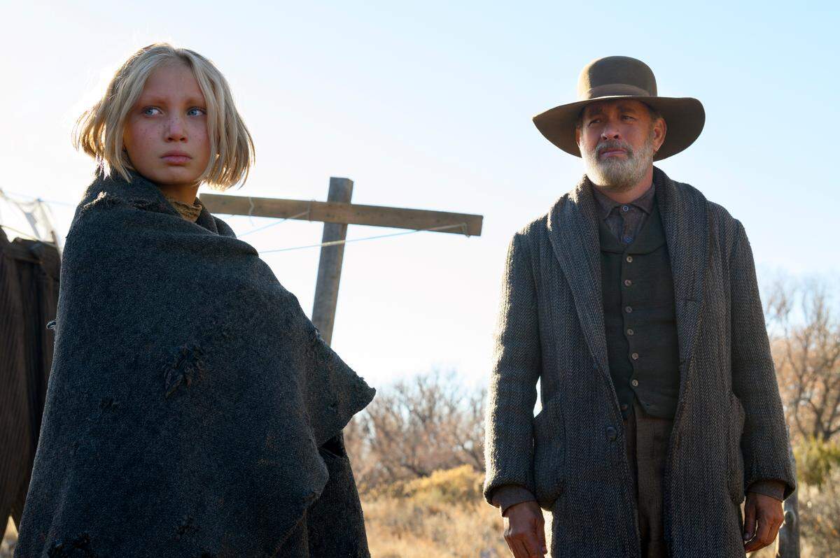 Helena Zengel, left, and Tom Hanks appear in a scene from “News of the World.” (Bruce W. Talamon/Universal Pictures via AP)