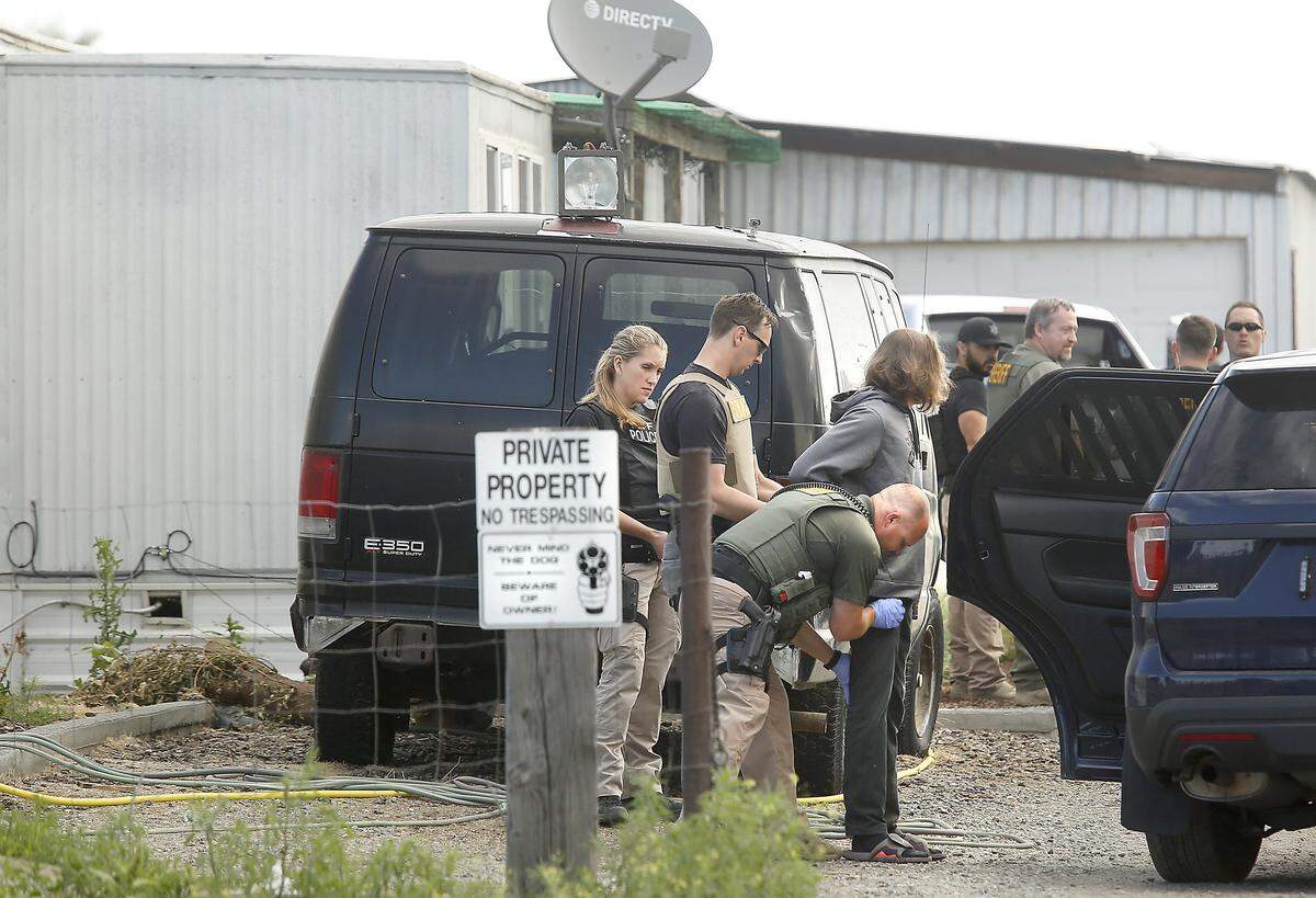 Law enforcement take an unidentified male suspect into custody at a single-wide mobile home in June at 14904 S 1977 PRSE in Finley. The operation was led by the Drug Enforcement Administration, and was part of a series of eight arrests.