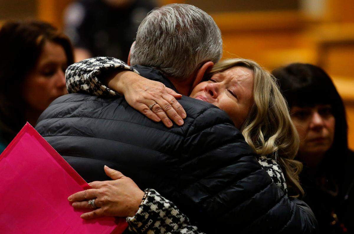 Widow Kris Mars is hugged by a supporter following Tuesday morning’s hearing in Benton County Superior Court.