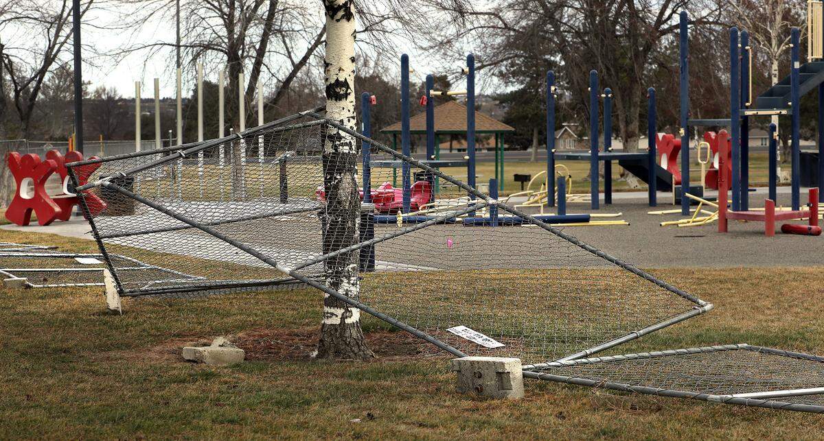 Temporary construction fencing surrounding the playground on February 25, 2025 at Lawrence Scott Park in west Kennewick is in disarray from being blown over by gusting winds. The playground, sitting partially disassembled, is shut down for the pending installation of a new inclusive playground equipment at the Kennewick city park. The construction project is expected to last until early May.
